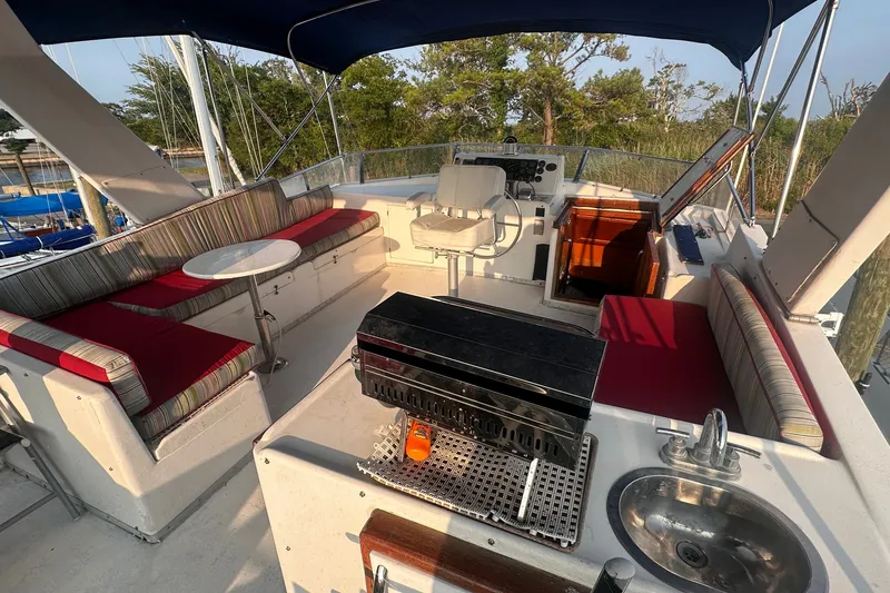 Slide: The Image of 1989 Jefferson Marquessa 52 yacht deck with seating, grill, and sink under canopy. - 44