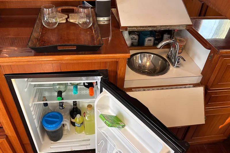 Slide: The Image of Mini bar setup on a 1989 Jefferson Marquessa 52 yacht with sink and fridge. - 15