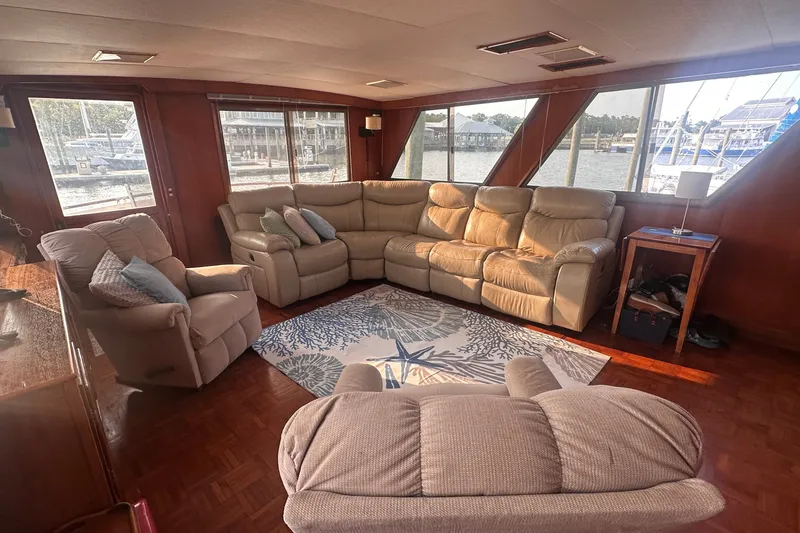 Slide: The Image of Luxurious interior of 1989 Jefferson Marquessa 52 yacht with plush seating and scenic windows. - 11