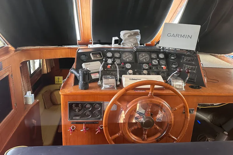 Slide: The Image of Cockpit of 1989 Jefferson Marquessa 52 yacht with Garmin navigation system and wooden steering wheel. - 9