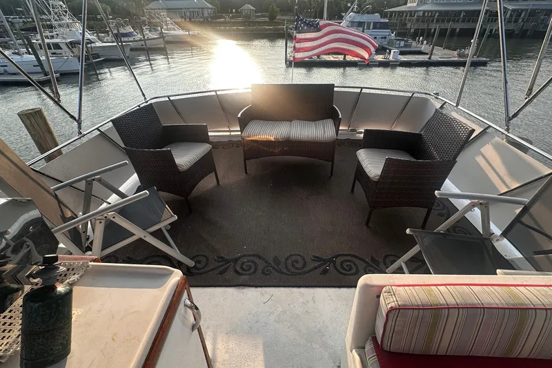 Slide: The Image of Aft deck of 1989 Jefferson Marquessa 52 yacht with seating and American flag. - 47