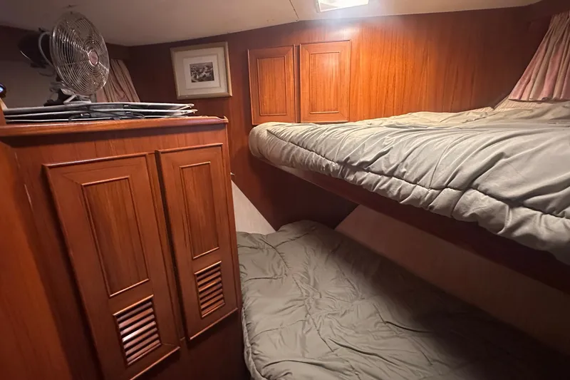 Slide: The Image of Cozy cabin interior of 1989 Jefferson Marquessa 52 yacht with wooden paneling and bunk beds. - 21