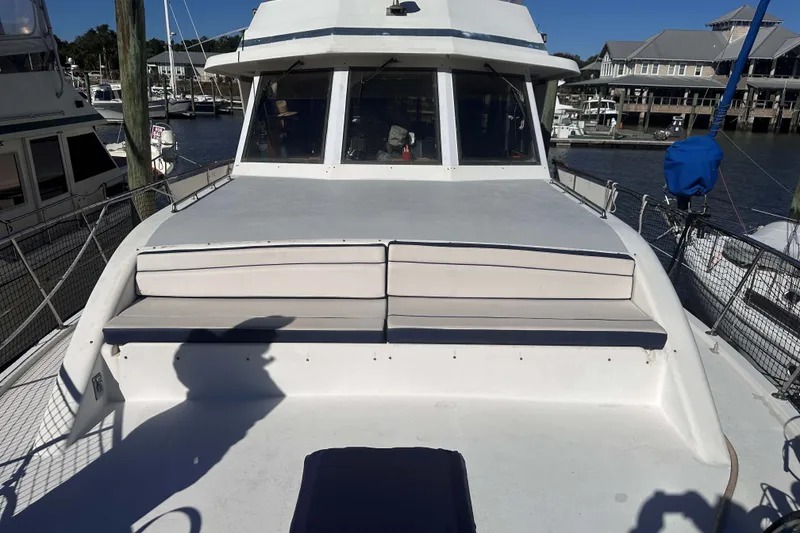 Slide: The Image of 1989 Jefferson Marquessa 52 yacht deck with seating, docked at marina. - 5