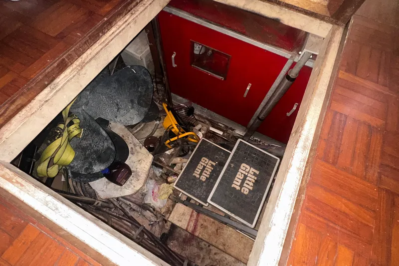 Slide: The Image of Storage compartment on 1989 Jefferson Marquessa 52 boat with tools and equipment. - 34