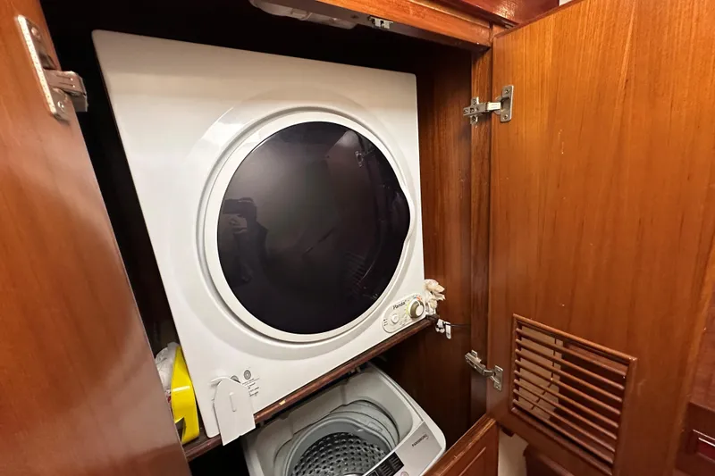 Slide: The Image of Laundry appliances inside a wooden cabinet on a 1989 Jefferson Marquessa 52 Extended Deckhouse. - 24