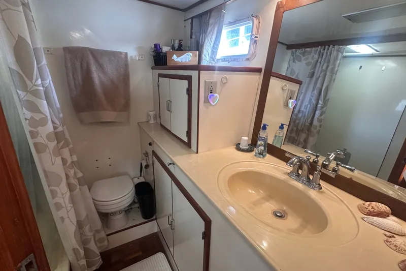 Slide: The Image of Bathroom interior of a 1989 Jefferson Marquessa 52 yacht, featuring sink and shower. - 32