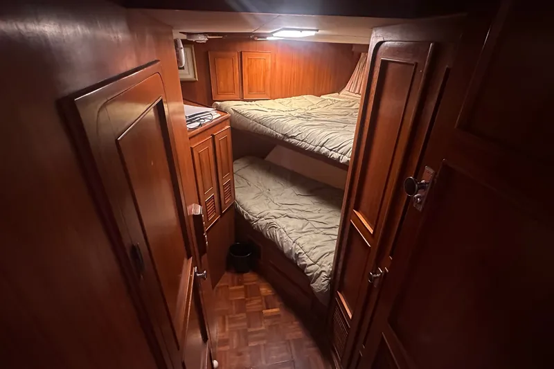 Slide: The Image of Cozy cabin with wooden interior and bunk beds on a 1989 Jefferson Marquessa 52 yacht. - 20