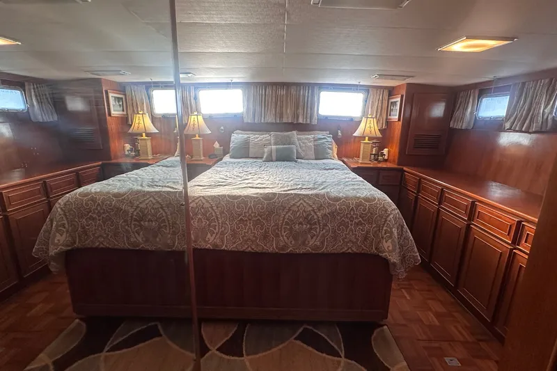 Slide: The Image of Luxurious bedroom interior of 1989 Jefferson Marquessa 52 yacht with elegant wood cabinetry. - 29