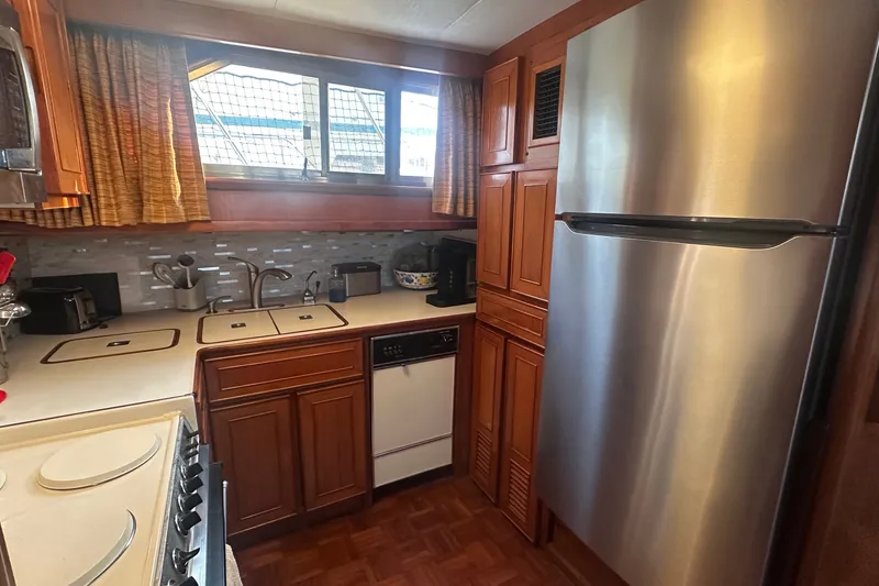 Slide: The Image of Galley kitchen in 1989 Jefferson Marquessa 52 yacht with stainless steel appliances and wood cabinetry. - 19