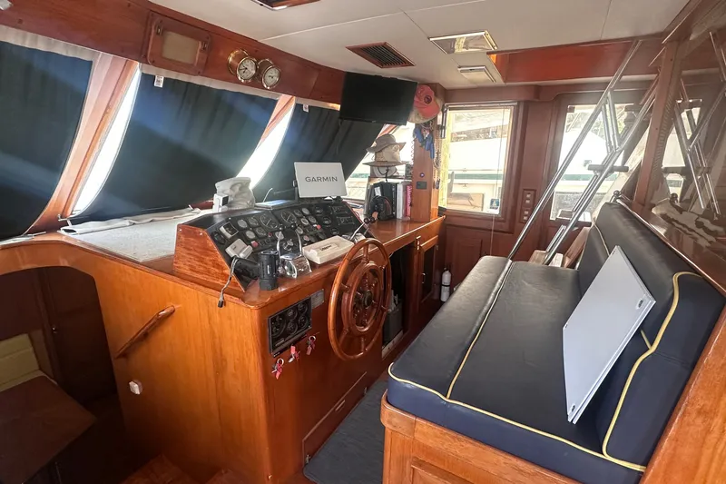 Slide: The Image of Interior of 1989 Jefferson Marquessa 52 yacht with helm, instruments, and seating area. - 7