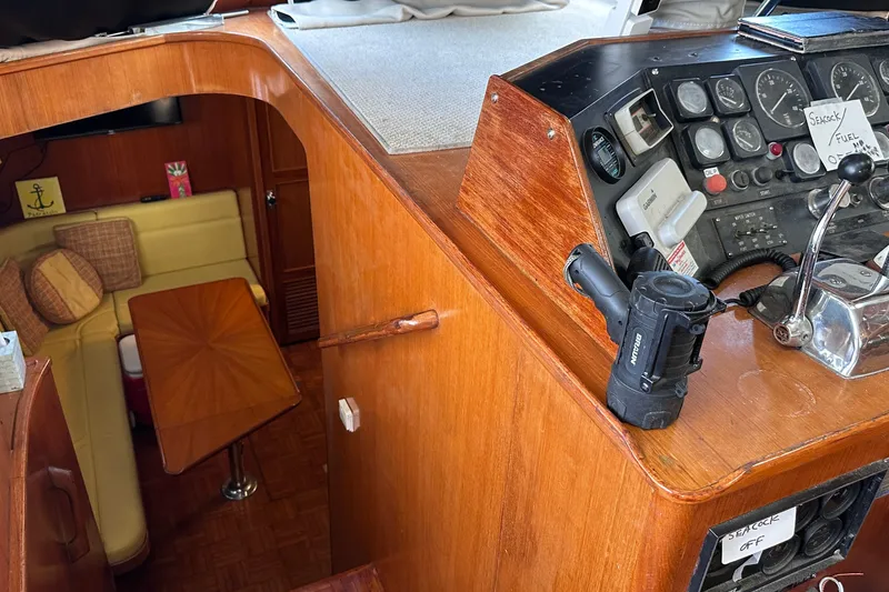 Slide: The Image of 1989 Jefferson Marquessa 52 yacht interior with helm, controls, and cozy seating area. - 16
