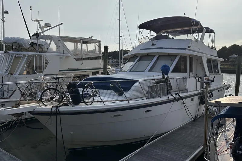 Slide: The Image of 1989 Jefferson Marquessa 52 Extended Deckhouse yacht docked with bicycles on deck. - 2