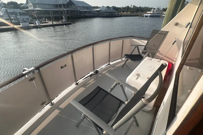 Slide: The Image of Deck view of 1989 Jefferson Marquessa 52 yacht with chairs and cooler. - 13