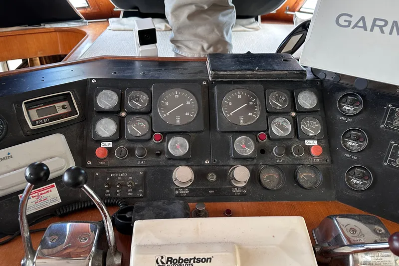 Slide: The Image of Control panel of a 1989 Jefferson Marquessa 52 Extended Deckhouse yacht, featuring gauges and navigation equipment. - 8