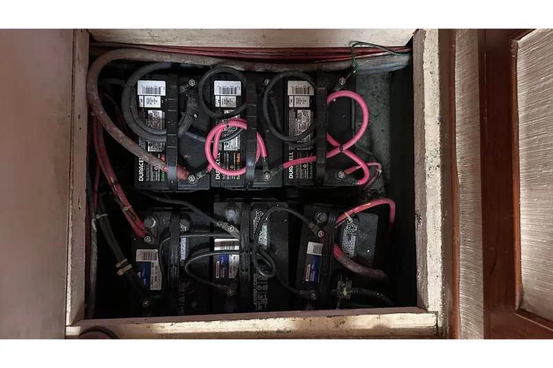 Slide: The Image of Battery compartment of 1989 Jefferson Marquessa 52 Extended Deckhouse with multiple connected batteries. - 43