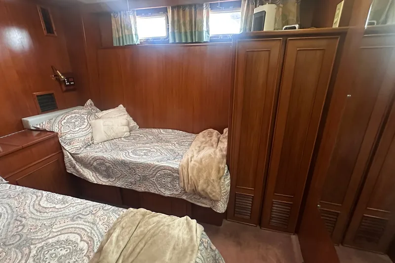 Slide: The Image of Cozy cabin interior of 1989 Jefferson Marquessa 52 yacht with twin beds and wood paneling. - 28