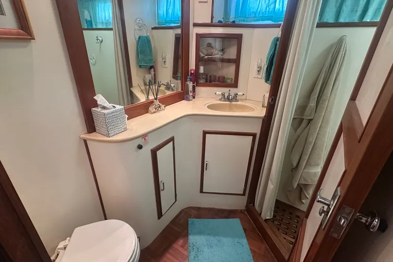 Slide: The Image of Bathroom interior of 1989 Jefferson Marquessa 52 yacht, featuring sink, shower, and toilet. - 25