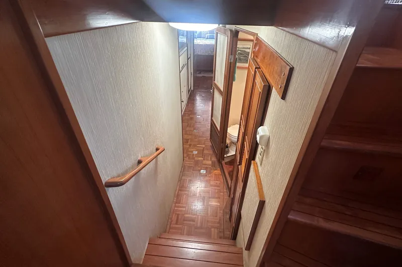 Slide: The Image of Interior hallway of 1989 Jefferson Marquessa 52 yacht with wooden flooring and handrail. - 23