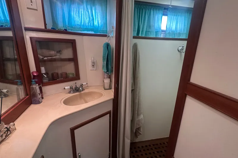 Slide: The Image of Bathroom interior of 1989 Jefferson Marquessa 52 yacht, featuring sink and shower area. - 26