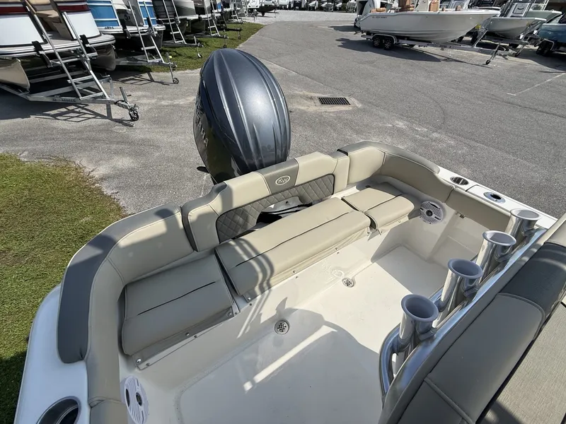 Slide: The Image of The image shows the stern of a Key West 203 FS boat with beige seating and rod holders. - 15