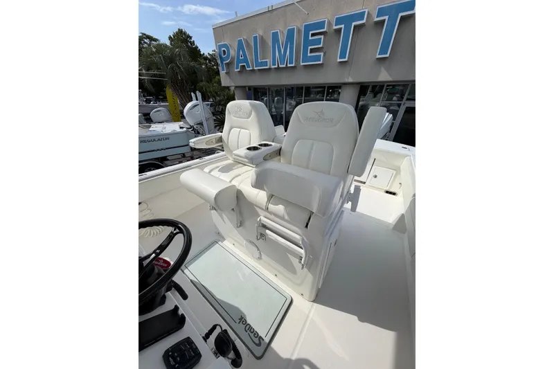 Slide: The Image of 2023 Regulator 31 boat interior with white seating at Palmetto dealership. - 17