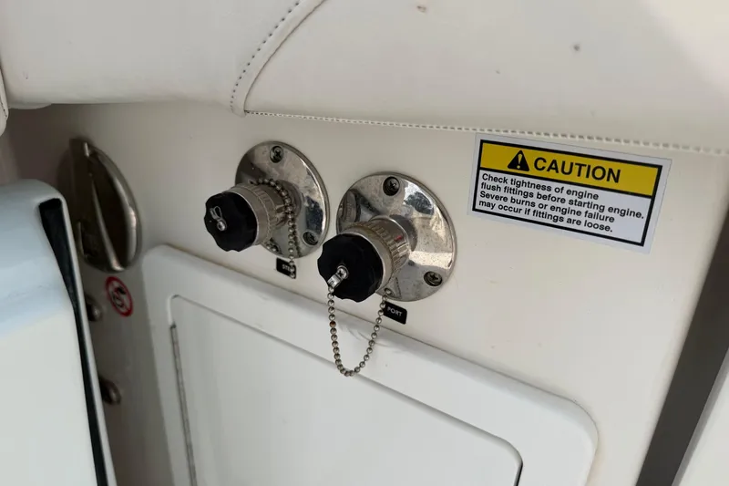 Slide: The Image of 2023 Regulator 31 boat engine flush fittings with caution label for safety. - 41