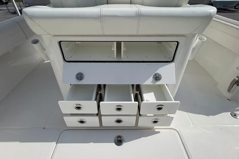 Slide: The Image of 2023 Regulator 31 boat storage compartments with open drawers and seating. - 22