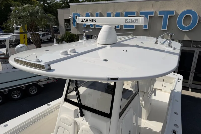 Slide: The Image of 2023 Regulator 31 boat with Garmin xHD2 radar, displayed at dealership. - 12