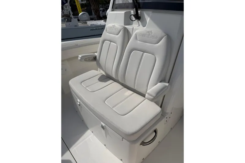 Slide: The Image of 2023 Regulator 31 boat seat with white cushioned upholstery and armrests. - 32