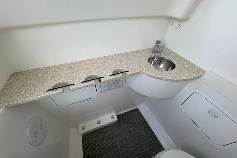 Slide: The Image of 2023 Regulator 31 boat interior with sink and countertop in compact bathroom. - 35