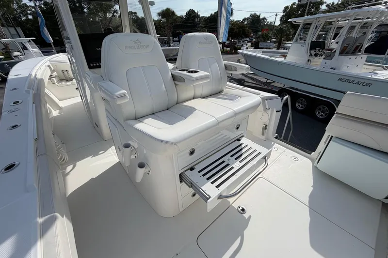 Slide: The Image of 2023 Regulator 31 boat interior with white seating and fishing rod holders. - 20