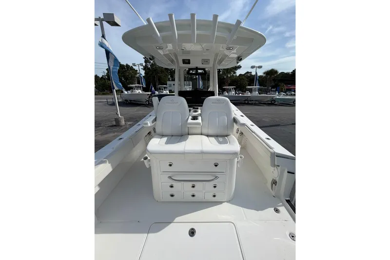Slide: The Image of 2023 Regulator 31 boat interior with white seating and storage compartments. - 19
