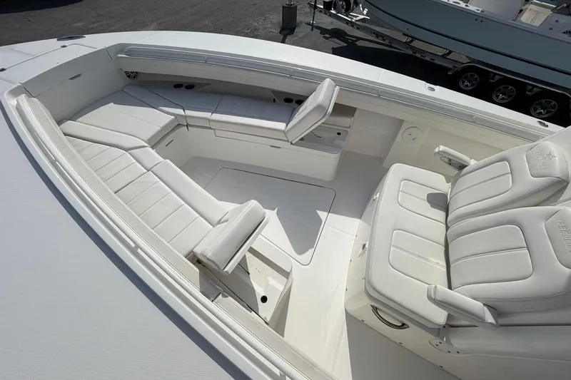 Slide: The Image of 2023 Regulator 31 boat interior with white cushioned seating and sleek design. - 29