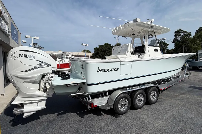 Slide: The Image of 2023 Regulator 31 boat with Yamaha XTO engine on a trailer. - 6