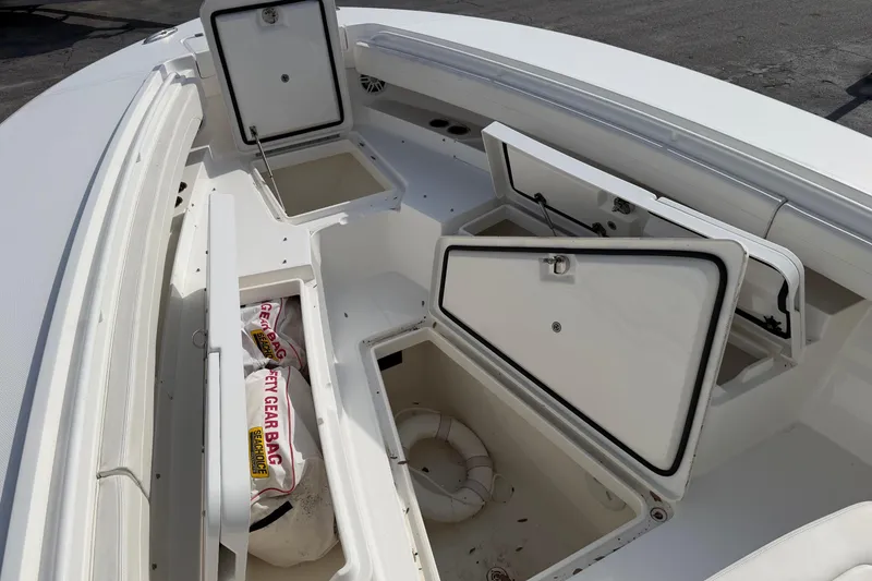 Slide: The Image of 2023 Regulator 31 boat with open storage compartments and safety gear bag. - 31