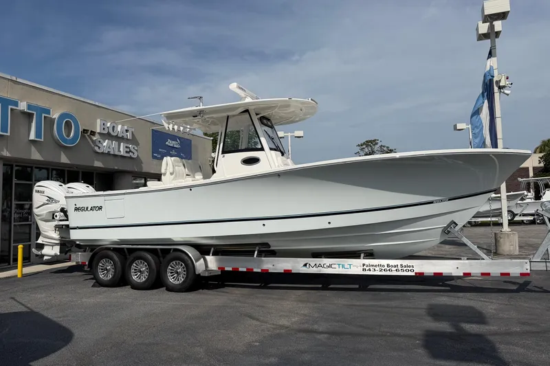 Slide: The Image of 2023 Regulator 31 boat on trailer at dealership, side view. - 4