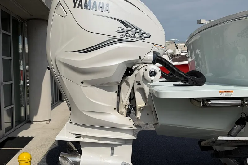 Slide: The Image of 2023 Regulator 31 boat with Yamaha XTO Offshore engine, docked outdoors. - 9