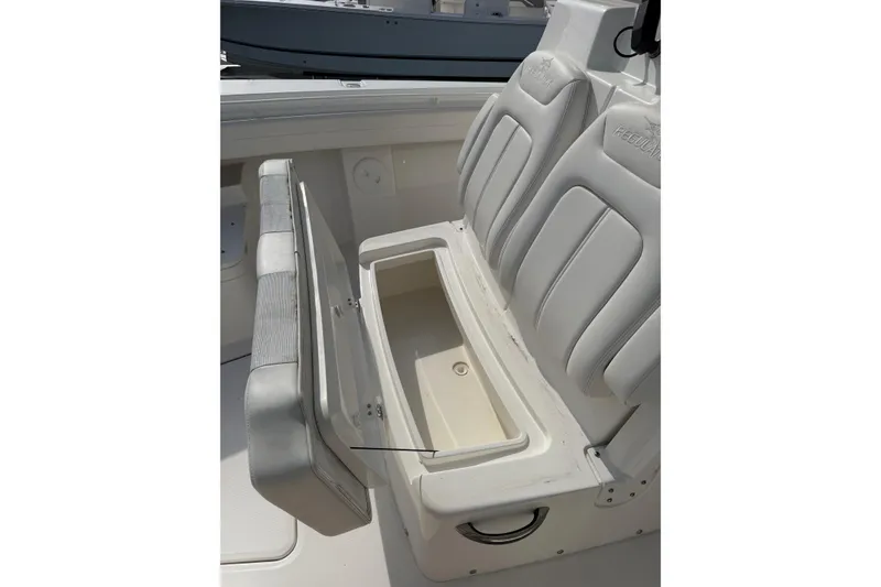 Slide: The Image of 2023 Regulator 31 boat seat with open storage compartment. - 33