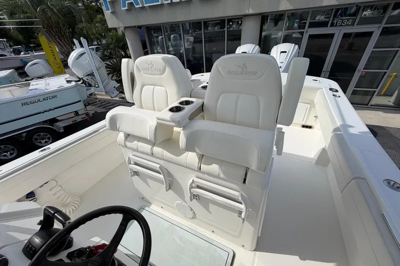 Slide: The Image of 2023 Regulator 31 boat with dual white captain's chairs and steering wheel. - 18