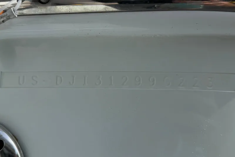 Slide: The Image of 2023 Regulator 31 boat hull identification number embossed on white surface. - 42