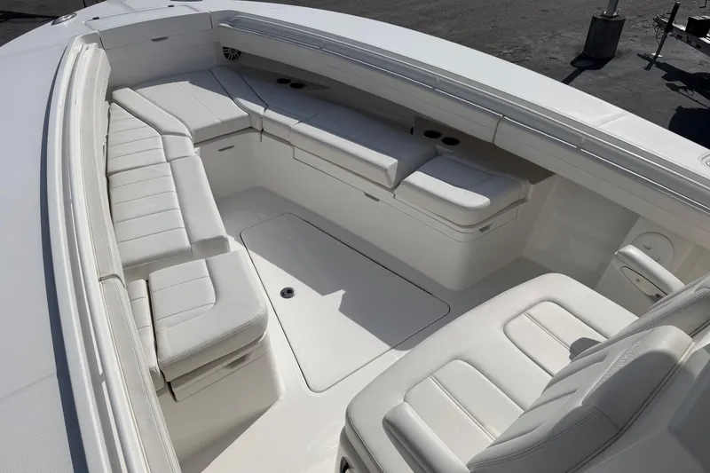 Slide: The Image of 2023 Regulator 31 boat interior with spacious white seating and storage compartments. - 26