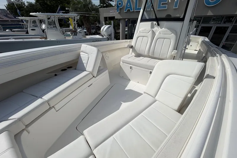 Slide: The Image of 2023 Regulator 31 boat interior with white seating and console, displayed outdoors. - 28