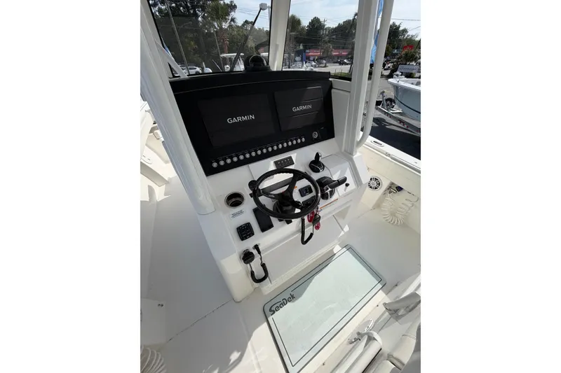 Slide: The Image of 2023 Regulator 31 boat console with Garmin displays and steering wheel. - 15