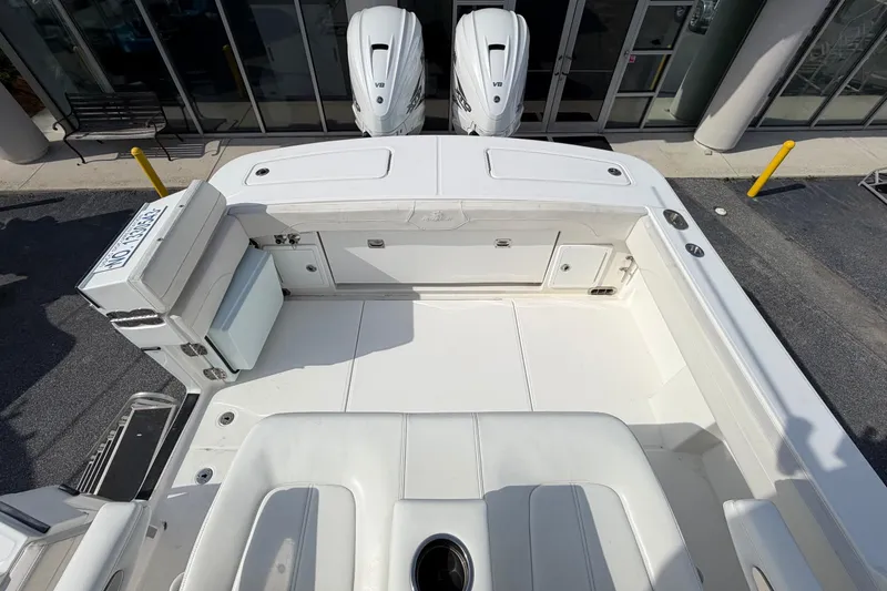 Slide: The Image of 2023 Regulator 31 boat deck with twin engines and seating area. - 23