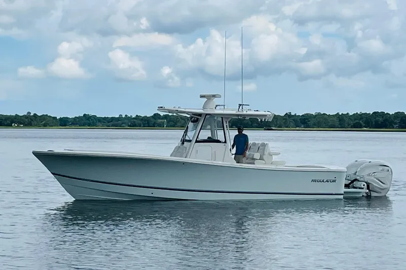Slide: The Image of 2023 Regulator 31 boat on calm water under cloudy sky. - 3