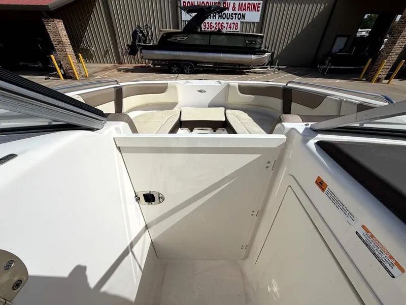 Slide: The Image of The image shows the cockpit of a 2019 Chaparral boat with beige seating and a table. - 20