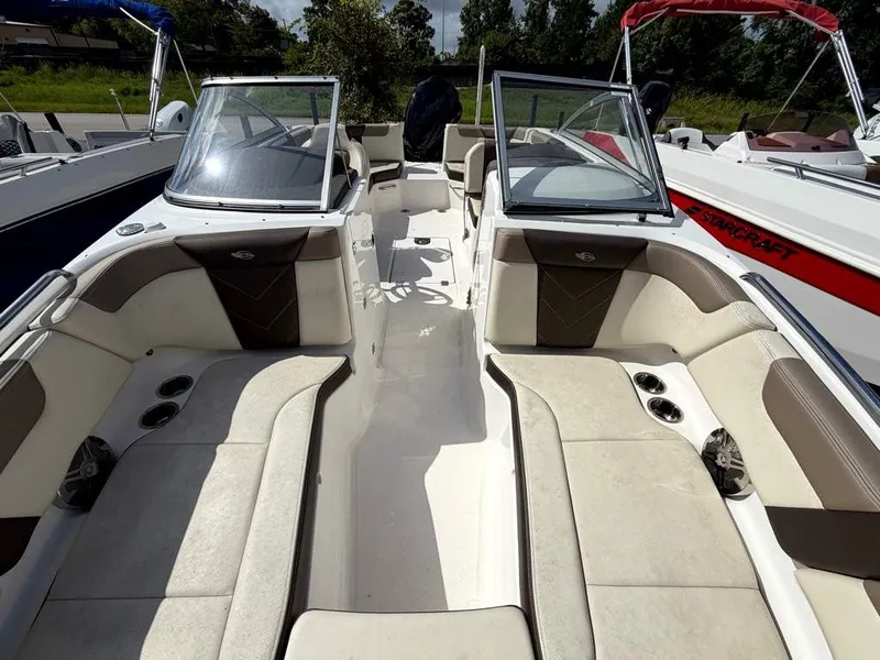 Slide: The Image of The image shows the interior of a 2019 Chaparral boat with beige and brown seating. - 19