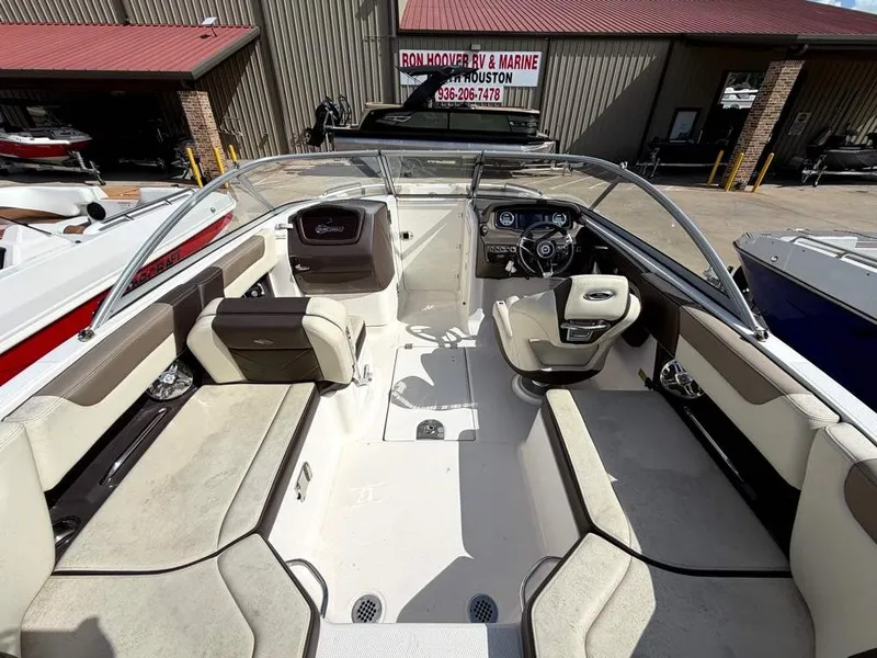 Slide: The Image of Interior view of a 2019 Chaparral boat with beige seating and a modern helm station. - 22