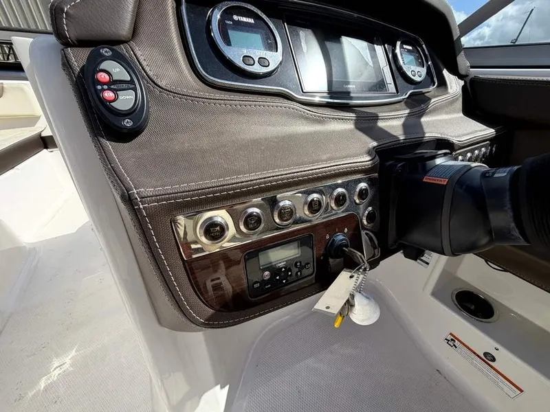 Slide: The Image of The image shows the dashboard of a 2019 Chaparral boat with various instruments and controls. - 15
