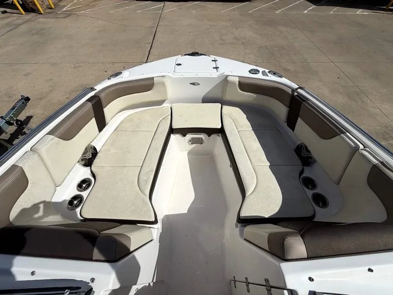 Slide: The Image of The image shows the bow area of a Chaparral boat with beige cushioned seats and cup holders. - 17